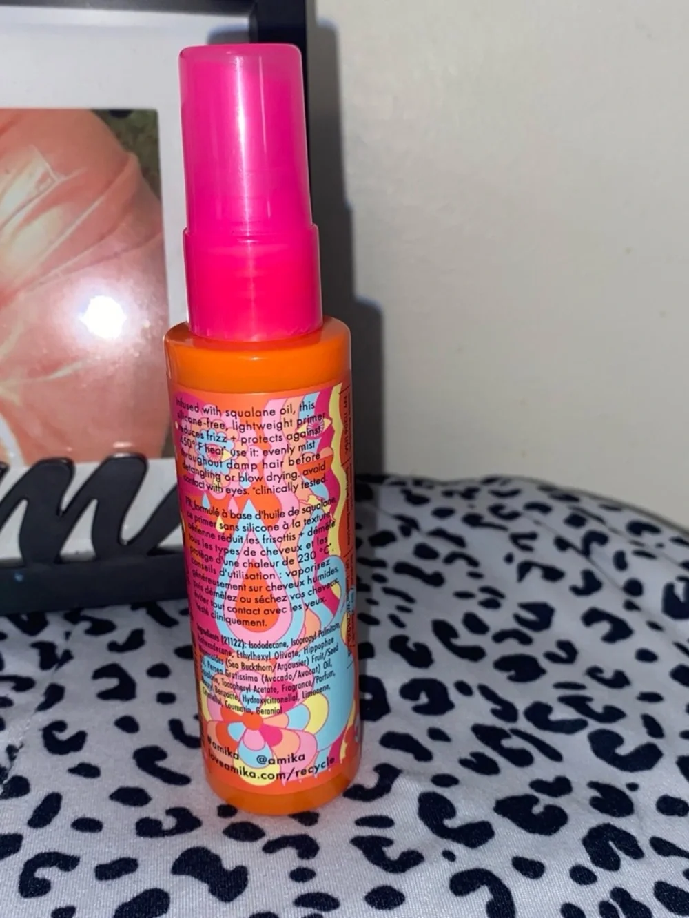 amika Bright Orange Bottle with Pink Cap Detangling Primer